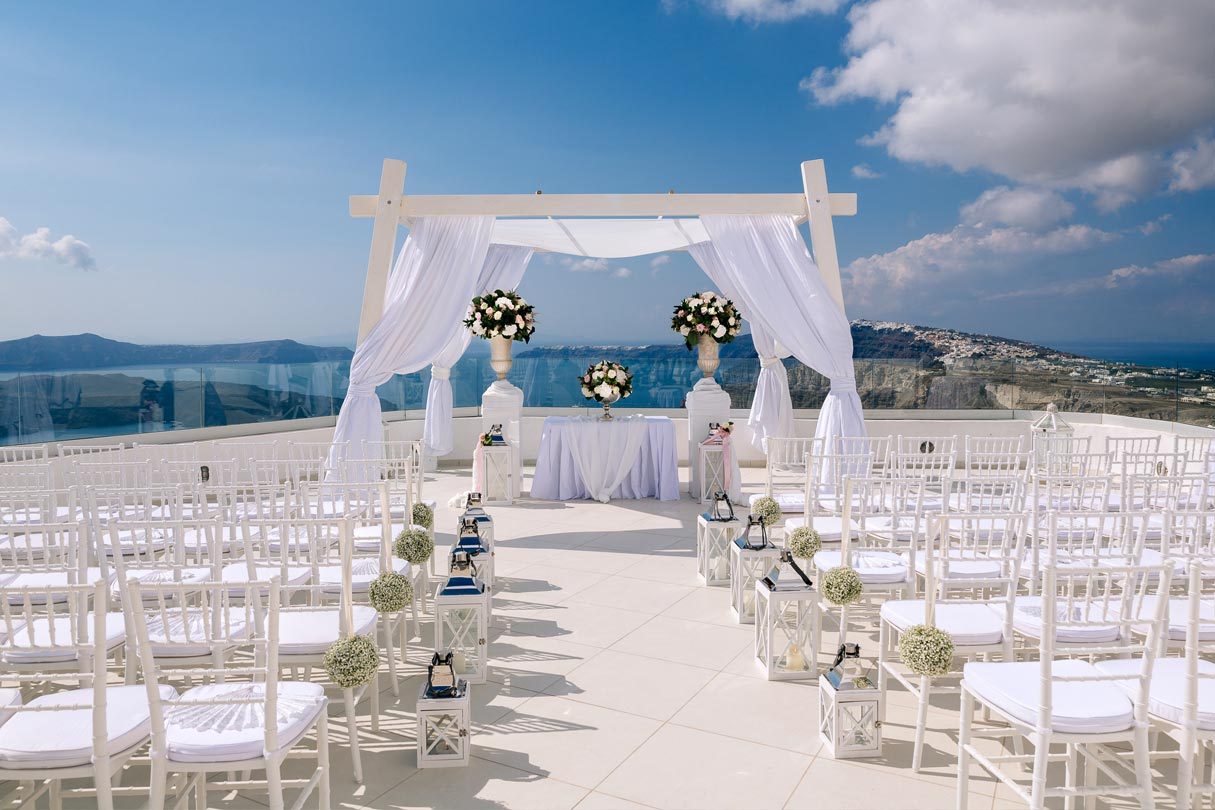 Ceremony aisle set with white chairs at Santo Winery